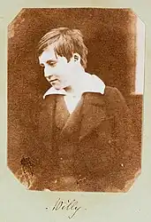 A photograph of Welsh boy, William Mansel (1838-1866) titled 'Willy', smiling at something off camera. Taken c. 1853, it is the earliest known photograph of a smile.