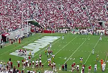 American football players near the end zone near the goal line.