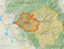 The Rim Fire is shown in orange having burnt into the Stanislaus National Forest (in green) and northwestern portions of Yosemite National Park (in gold stripes).