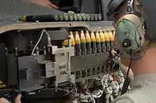 30mm × 113&nbsp;mm rounds being loaded into a M230 chain gun