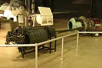 German BK 5 50&nbsp;mm aircraft autocannon displayed in front of the Me 262A jet, a design once tested with it