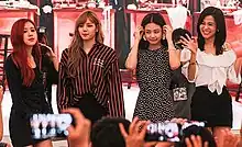 Blackpink standing in front of a crowd