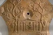 Detail of an oil lamp with the triad, 75–100 AD (Allard Pierson Museum)