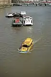 Amphibious tour bus – a converted DUKW – on Thames river in London near Lambeth Bridge.