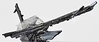 Antimonite crystals (longest crystal: 7&nbsp;cm) intergrown with calcite (length: 3&nbsp;cm) from Xikuangshan Mine
