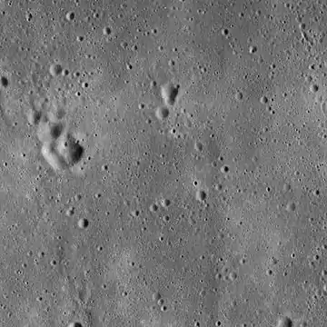 Lunar Orbiter 5 image from 1967, cropped to show the vicinity of the landing site of Apollo 11, used in mission planning.  The image is centered precisely on a small crater called West crater (190 m in diameter), and the lunar module Eagle touched down about 550 m west of West Crater. The area shown is approximately 25&nbsp;km × 25&nbsp;km across.