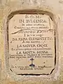 Terracotta plaque walled into the façade of the church of Santa Caterina