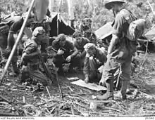 A group of soldiers receive orders prior to a patrol
