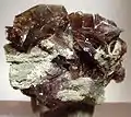 Clove-brown axinite crystals to 2.3&nbsp;cm set atop matrix from the West Bor Pit at Dalnegorsk, Russia