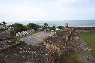 Youth playing basketball at a court at La Perla