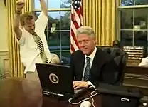 President Bill Clinton (right) with television actor Mike Maronna (left) celebrating a successful online purchase in a comedic short film recorded for the 2000 Dinner.