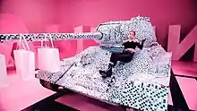 Jennie sitting atop a diamond-encrusted tank on the set of the music video