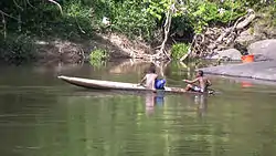 Boys in a canoe on the Gran Rio river
