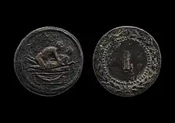 A spintria token showing sex between two males on a bed. On the other side is a numeral.