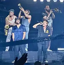 Lawrence (bottom row, left) with The Hooligans in 2024