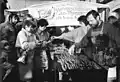 Border crossers being treated to free sausages, sandwiches, wine, coffee and cake on the Thuringian side of the new border crossing between Herleshausen and Lauchröden in Eisenach in December 1989.