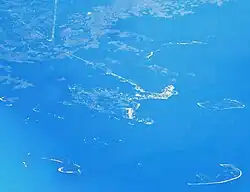 Aerial view of Cedar Key and its outlying islands, illustrating the extremely small size of the city: The fork at State Road 24 and County Road 347 (the only two access roads) can be seen in the upper left.