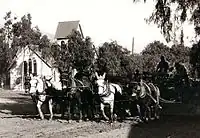 Central Ave, Sierra Madre, CA in 1905. A mule team is grading the Ave for the installation of the 1906 Pacific Electric street car, in the background is the Old North Church with the original barn roof bell tower.