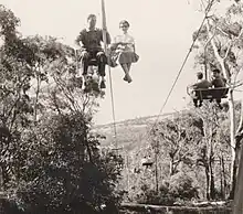 View of a chairlift from below with chairs passing up and down