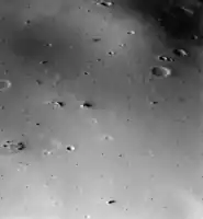 The surface of Deimos, a moon of Mars, is covered by a layer of regolith estimated to be 50 m (160 ft) thick. Viking 2 orbiter image is from a height of 30 km (19 mi).