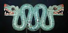Double-headed serpent; 1450–1521; Spanish cedar wood (Cedrela odorata), turquoise, shell, traces of gilding & 2 resins are used as adhesive (pine resin and Bursera resin); height: 20.3&nbsp;cm (8.0&nbsp;in), width: 43.3&nbsp;cm (17.0&nbsp;in), depth: 5.9&nbsp;cm (2.3&nbsp;in); British Museum