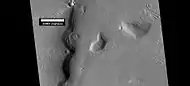 Layered features, as seen by HiRISE under HiWish program. On the right side of picture a small region of ribbed upper plains material is changing into brain terrain.