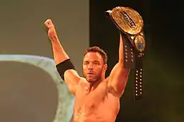 Eli Drake with the fourth title belt design; the "Impact Wrestling" plate was added to the title belt to cover the Global Force Wrestling logo after the company's brief use of that name