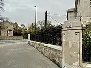 Boundary wall and gate pier with Greek patterns