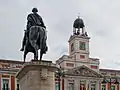 Monument to King Charles III in front of the House of the Post Office
