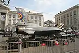 A fighter jet parked in the street