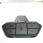 Xbox One Stereo Headset Adapter, a black plastic attachment that plugs into the bottom of the Xbox One Wireless Controller and provides a standard 3.5&nbsp;mm stereo headset jack with microphone contact. The adapter itself is roughly trapezoidal and has five buttons on its face; two buttons on the left to balance audio output between in-game chat (bottom) and game (top); a large center button to mute the chat microphone; and two buttons on the right to increase (top) or decrease (bottom) overall volume.