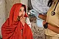 An Afghan girl receiving treatment from an American medic in Oruzgan Province