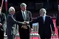 U.S. President Bill Clinton watches Jordan's King Hussein and Israeli Prime Minister Yitzhak Rabin shaking hands, October 1994
