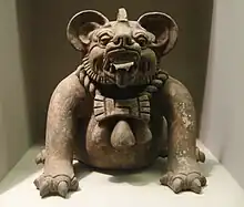 A funerary urn in the shape of a "bat god" or a jaguar, from Oaxaca, Mexico, dated to 300–650 CE.  Height: 9.5 in (23&nbsp;cm).