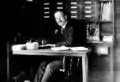 Photograph of George Ellery Hale at work at his desk.