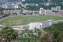 A racecourse surrounded by city buildings