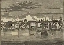 A lithograph of a ship entering a port where slaves wait on a dock