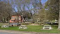 Looking across the park downtown towards the old Banks County Courthouse, the large brick building in the left background