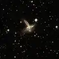 ESO 593-8 is an impressive pair of interacting galaxies with a feather-like galaxy crossing a companion galaxy.