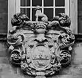 Arms above front door.
