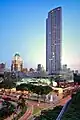 Side view of a 56-storey building attached to a luxury shopping mall in the foreground.