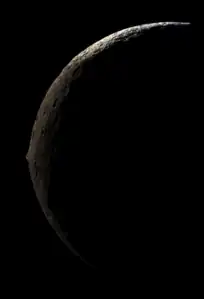 An image of Iapetus from its nightside that was photographed by an approaching Cassini, showing it as a slender crescent with its massive equatorial ridge clearly visible at the middle. This image was taken on September 10, 2007 at a distance of 83,000 kilometers (51,600 miles).