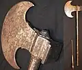 Sindhi tabar battle axe, late 18th century or earlier, crescent shape 12&nbsp;cm (5&nbsp;in) long head with a square hammer opposite of the blade, 55&nbsp;cm (22&nbsp;in) long steel haft, the end of the haft unscrews to reveal a 12&nbsp;cm (5&nbsp;in) slim blade. Heavily patinated head and handle with traces of engraving.