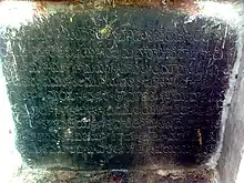 An inscription written on a black slab in Telugu language.