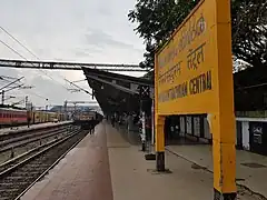Looking down a platform as a train pulls in