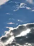 Irisation in cirrus (or maybe cirrocumulus) clouds behind Stratocumulus (bottom), in the afternoon over Warsaw, Poland.