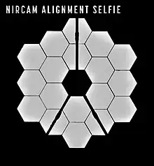 18 primary mirrors of the James Webb Space Telescope reflected in the secondary mirror