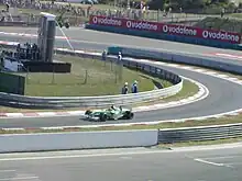 Photograph of Wilson driving his Jaguar into the pit
