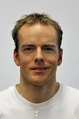Jens Filbrich wearing a cross necklace
