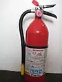 A typical dry chemical extinguisher containing 5 lb (2.3 kg) of monoammonium phosphate dry chemical